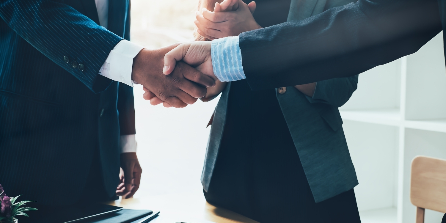 Two businessmen shaking hands for partnership