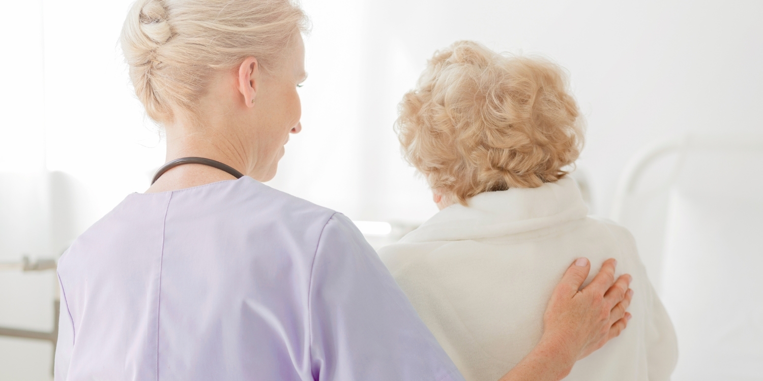 Caregiver sitting beside hospice patient