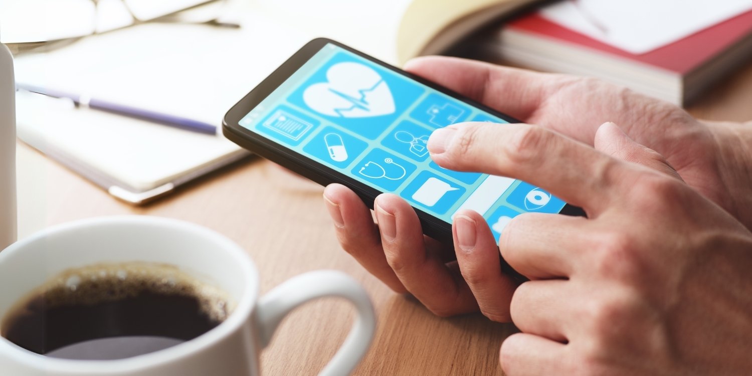 Hand tapping a healthcare app on a smartphone.