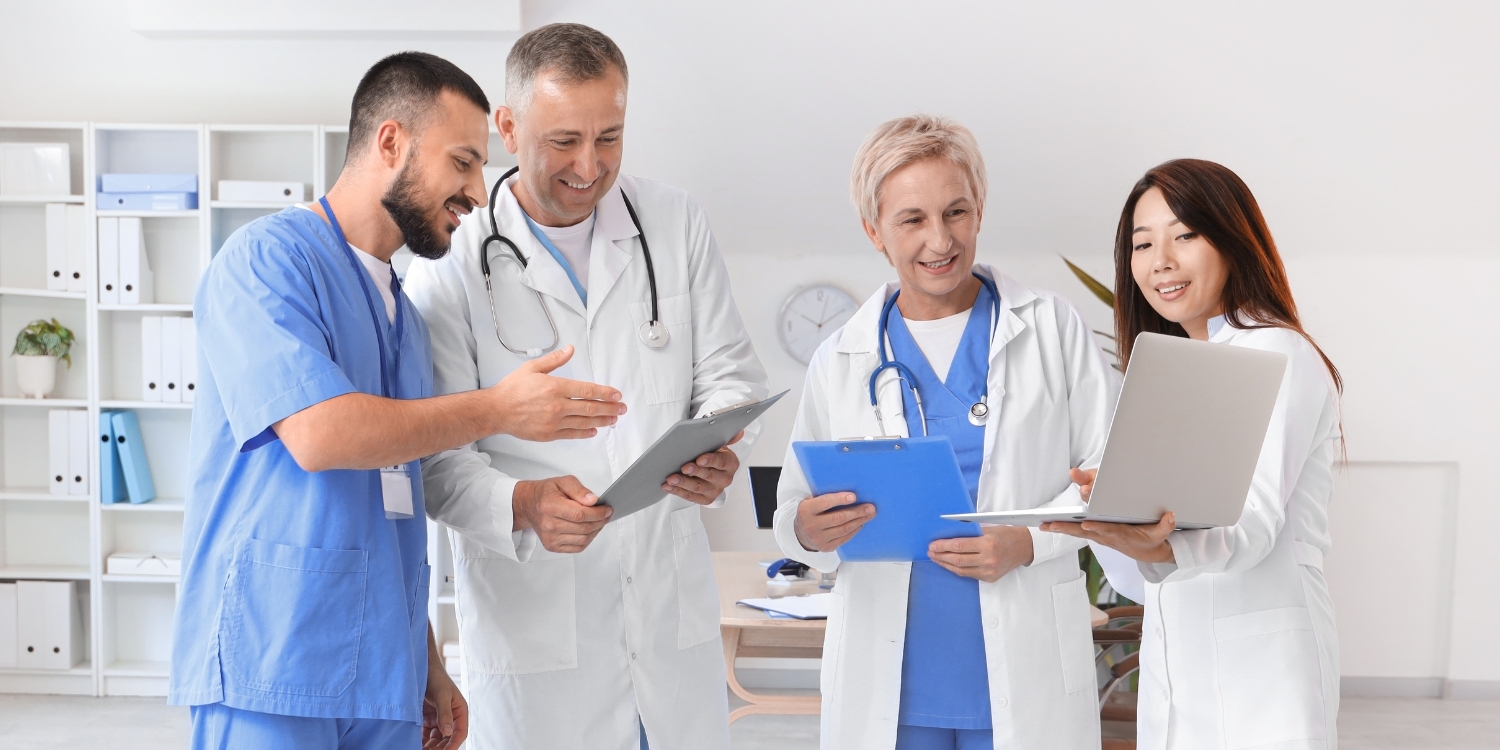 Interdisciplinary team of clinicians comparing notes