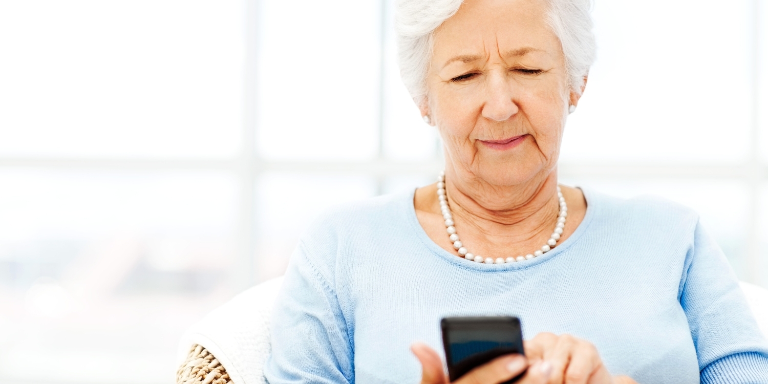 Elderly woman texting.