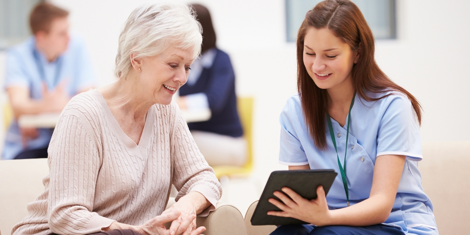 Clinician showing tablet screen to patient