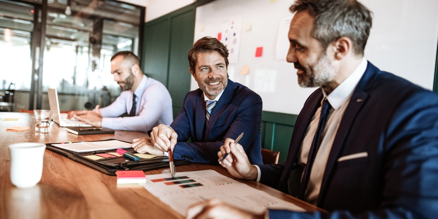 Professionals smiling while reviewing financials