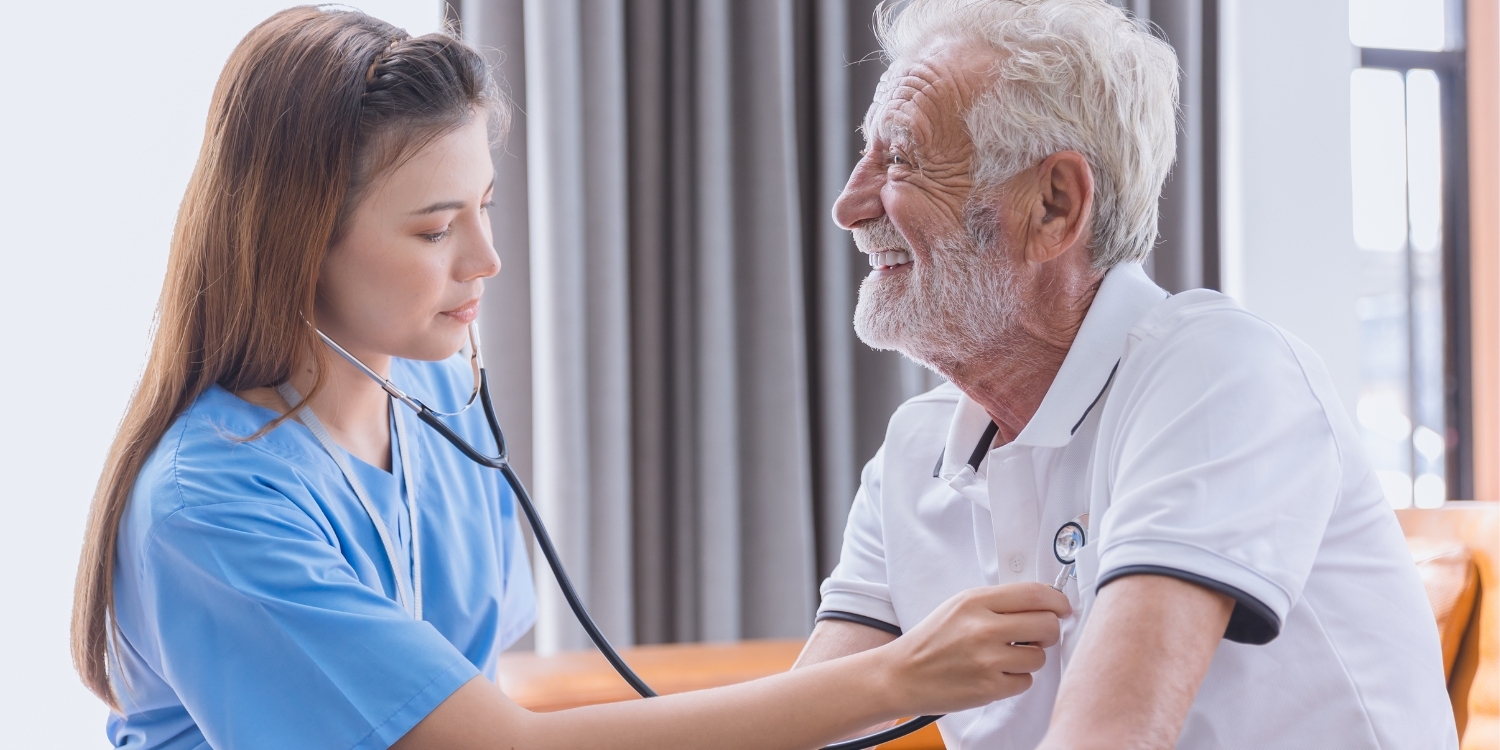 Clinician checking heartbeat of patient in-home